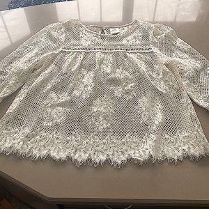 White long sleeve lace blouse with button detail on back.